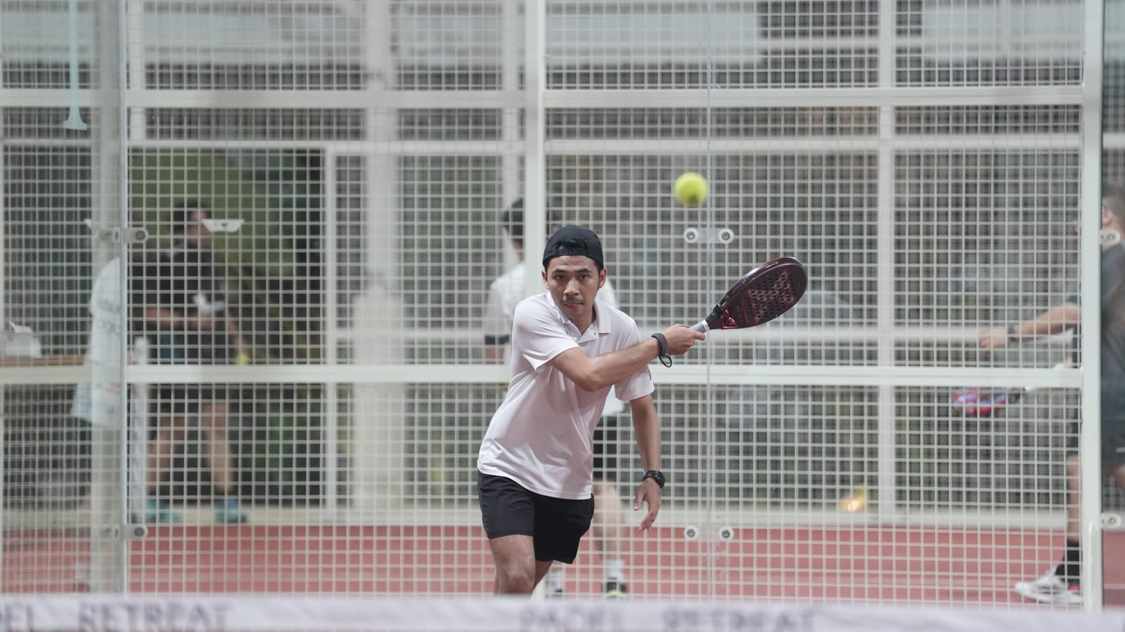 Premium indoor padel court lit for evening play