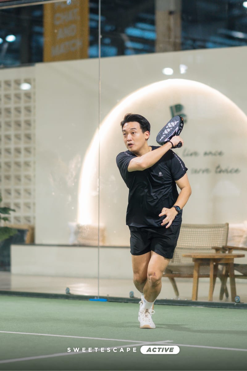 Indoor padel court with bright overhead lights